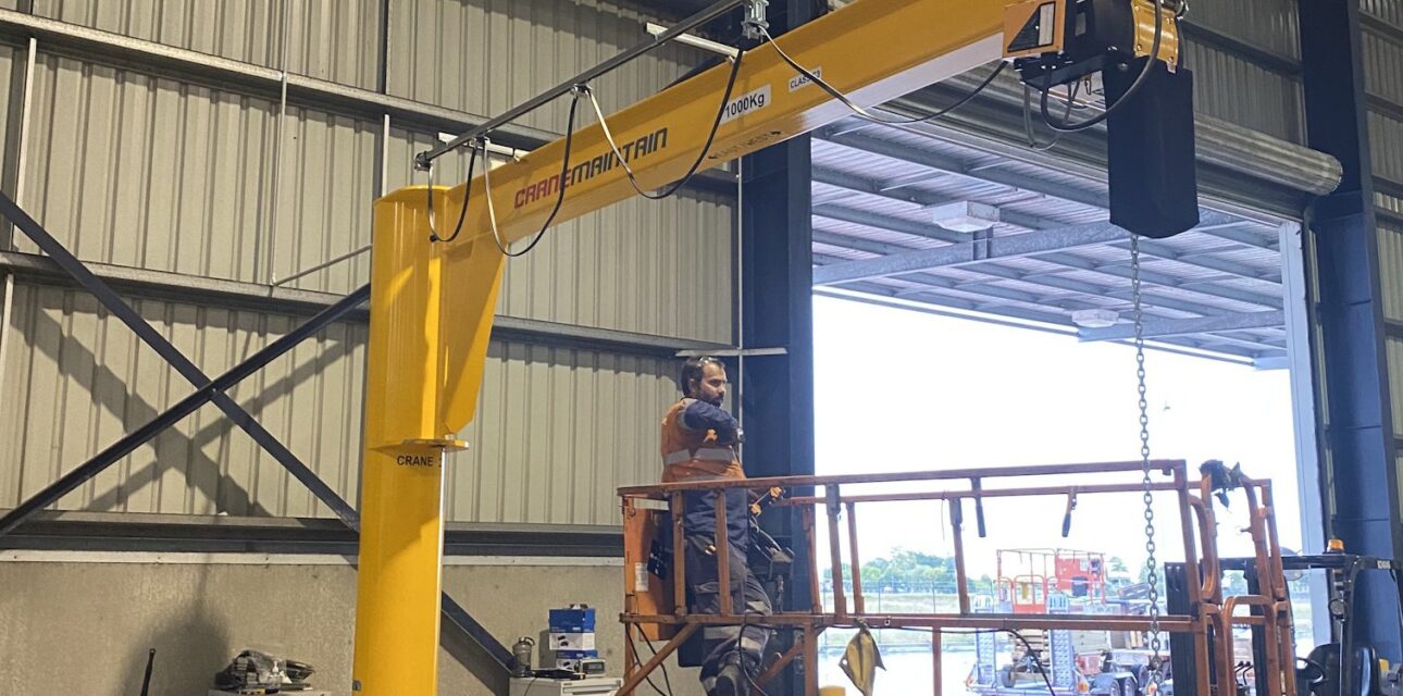 Free‑standing jib crane with Yale electric hoist being installed.