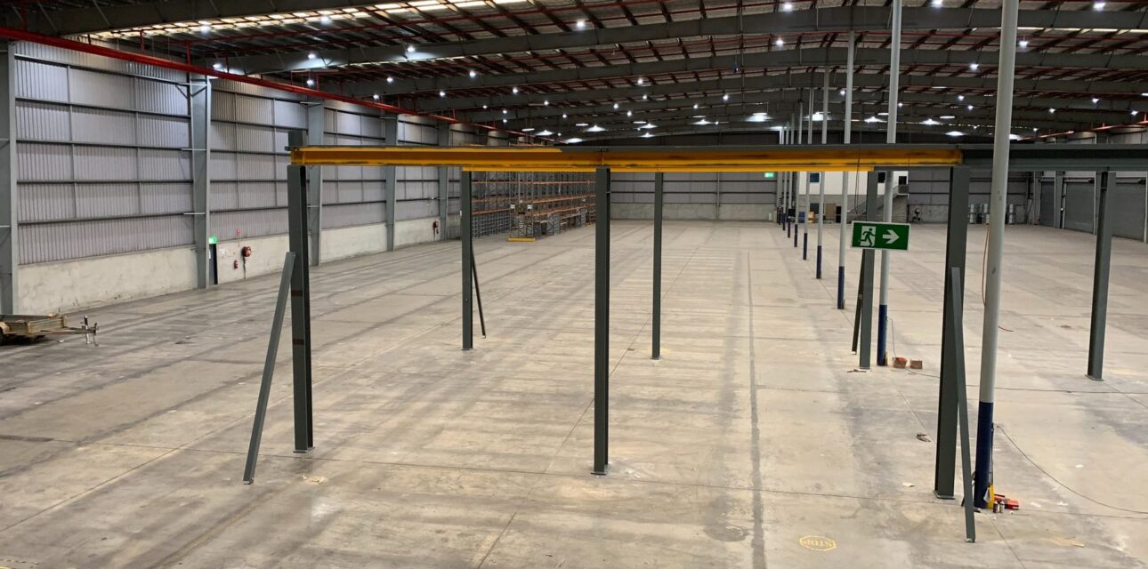 Overhead crane runway beams and support columns installed in an industrial warehouse