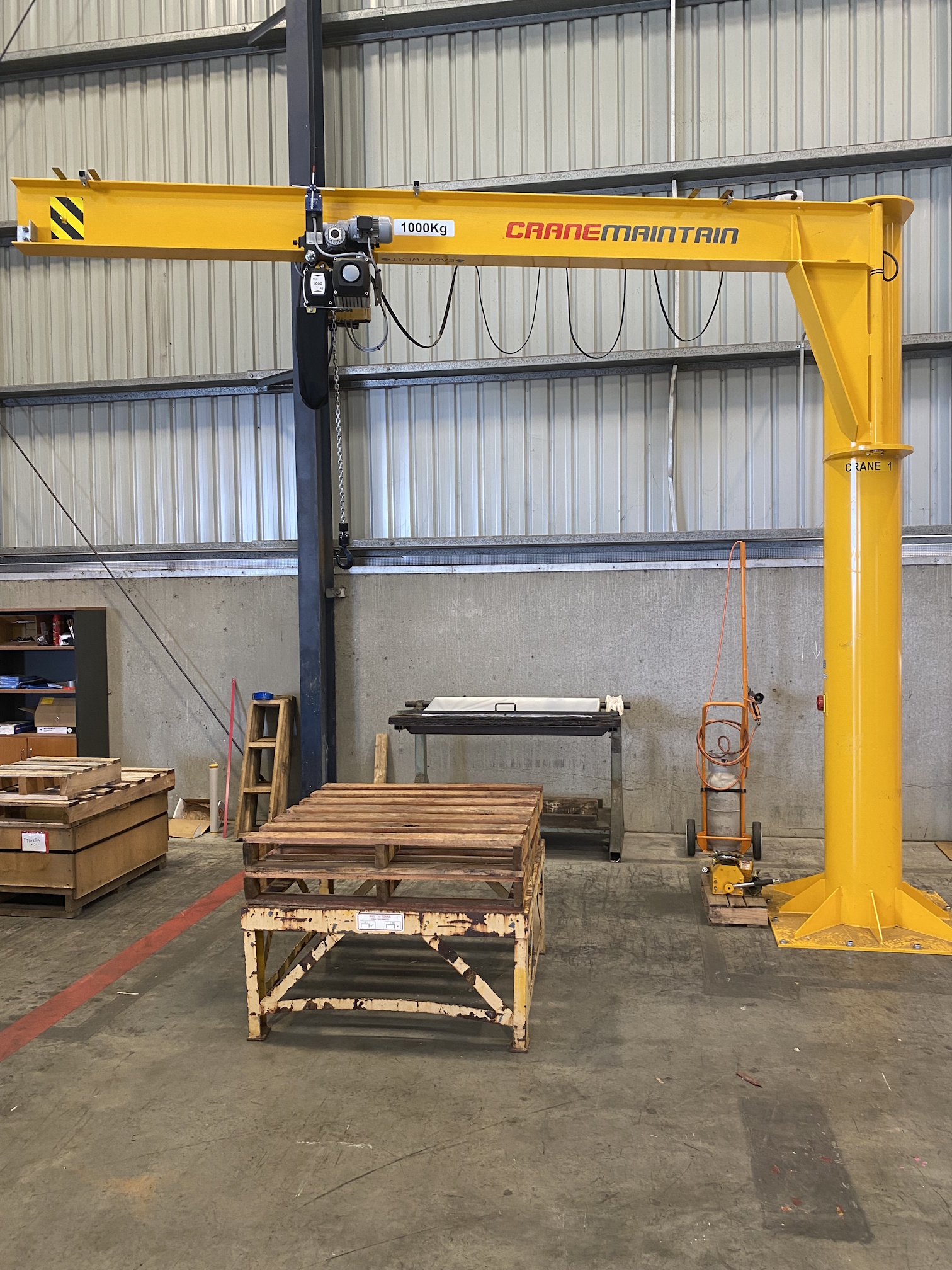 Installed jib crane and overhead lifting equipment in an industrial workshop