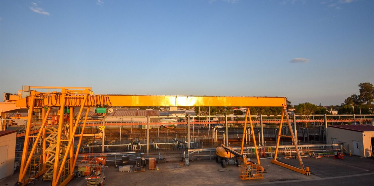 Large outdoor portal crane system at an industrial rail facility